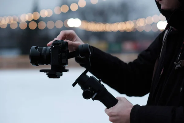 Video Making with the stabilizer. Man recording a video with a slr camera and gimbal