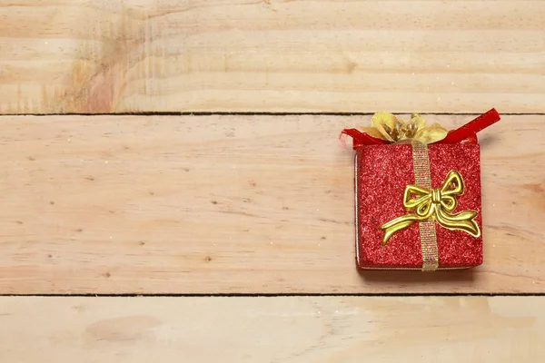 Time gifts - gift box on wood table.Winter holiday theme. Happy New Year. Space for text.
