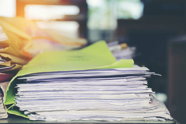 Paper documents stacked in archive. Vintage color.