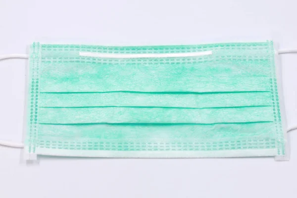 Surgical mask with rubber ear straps. mask to cover the mouth and nose corona virus protection isolated on a white background.