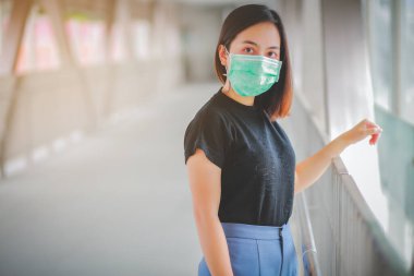 PM2.5 'u korumak için maske takan Asyalı kadın ve Covid-19 virüslü öksürük..