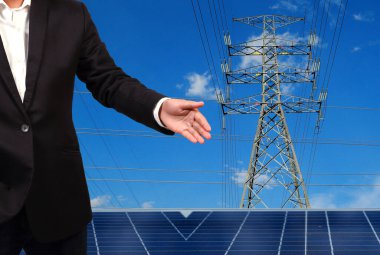 Yüksek voltaj kulelerine karşı güneş paneli olan mühendis..