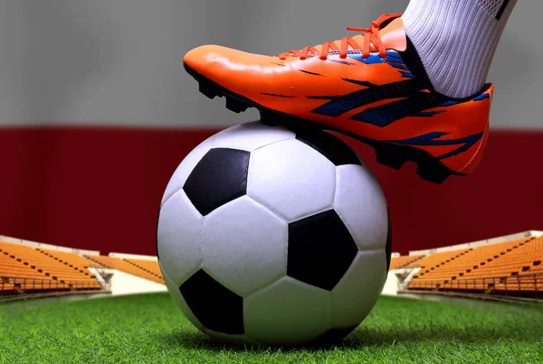 Close up legs and feet of soccer player or football player walk on green grass ready to play match on national Poland flag background.