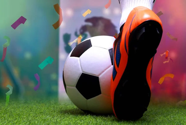 Close up legs and feet of soccer player or football player walk on green grass ready to play match on national Mexico flag background.