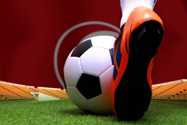 Futbol oyuncusunun bacakları ve ayakları kapalı ya da futbolcu yeşil çimlerin üzerinde yürüyor ulusal Tunus bayrağı arka planında oynamaya hazır..