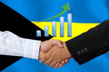 Arka plan olarak BAHAMA bayrağı ile el sıkışma veya sözleşme.