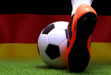 Futbol oyuncusunun bacakları ve ayakları kapalı yeşil çimlerde yürür ulusal Alman bayrağı arka planında oynamaya hazırdır..