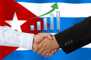 Arkaplan olarak Küba bayrağı ile el sıkışmak ya da sözleşmek.