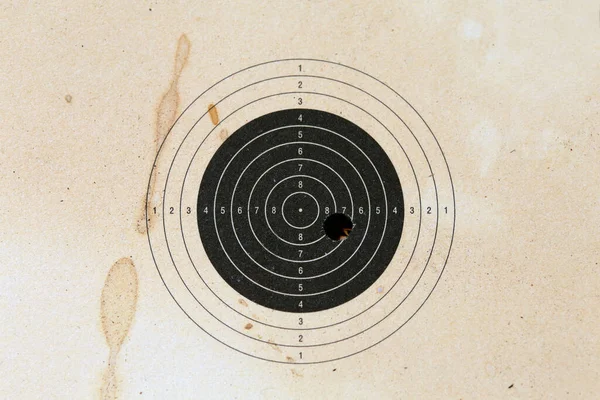 Bull eye target with bullet hole