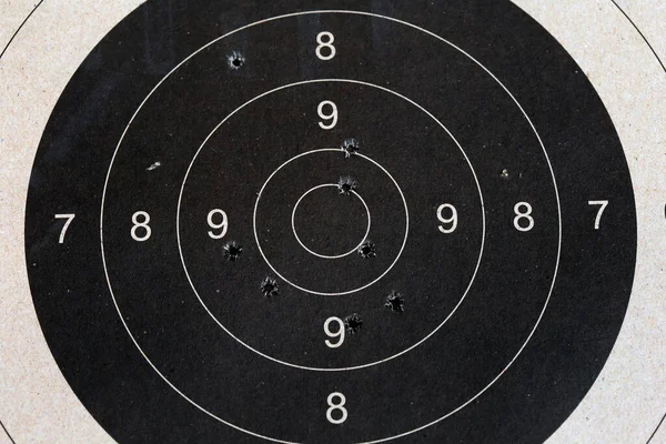 Bull eye target with bullet hole