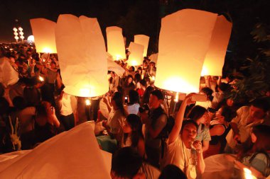 İnsanlar 24 Kasım 2012 'de Chiangmai, Tayland' da Buda 'nın eserlerine ibadet etmek için gökyüzü fenerlerini salıverirler. Bu festival her 12 dolunayda gerçekleşir..
