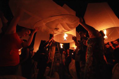 İnsanlar 24 Kasım 2012 'de Chiangmai, Tayland' da Buda 'nın eserlerine ibadet etmek için gökyüzü fenerlerini salıverirler. Bu festival her 12 dolunayda gerçekleşir..