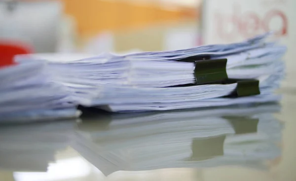 Paper business documents of unfinished stacked on office desk archive,in archive analyzing the market and considers on the size of future profits on table office.