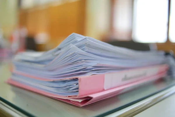 Paper business documents of unfinished stacked on office desk archive,in archive analyzing the market and considers on the size of future profits on table office.