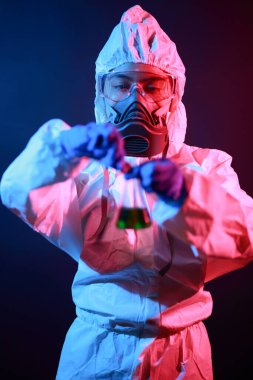 Bilim adamı laboratuarda renk tonu efekti üzerine sıvı dolu bir test tüpü tutuyor..