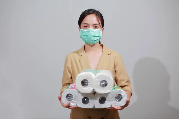 Asian woman storing tissue toilet paper during Coronavirus outbreak or Covid-19, Concept of Covid-19 Dangerous virus, Doomsday panic people panic.