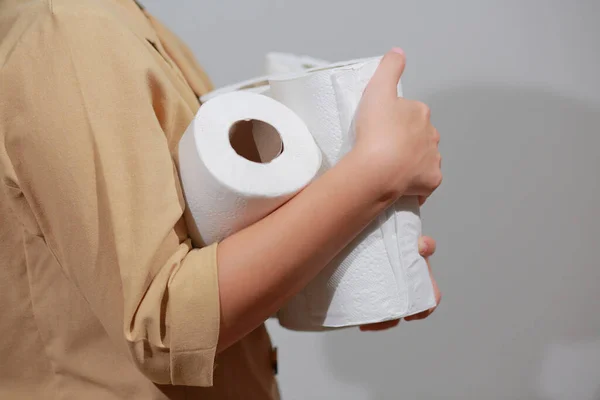 Asian woman storing tissue toilet paper during Coronavirus outbreak or Covid-19, Concept of Covid-19 Dangerous virus, Doomsday panic people panic.