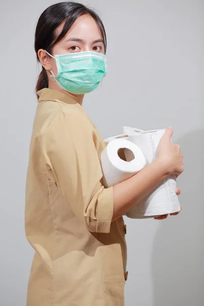 Asian woman storing tissue toilet paper during Coronavirus outbreak or Covid-19, Concept of Covid-19 Dangerous virus, Doomsday panic people panic.