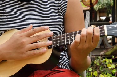 The girl was playing ukulele.