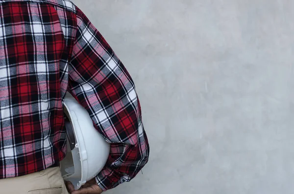 worker with hard hat under arm