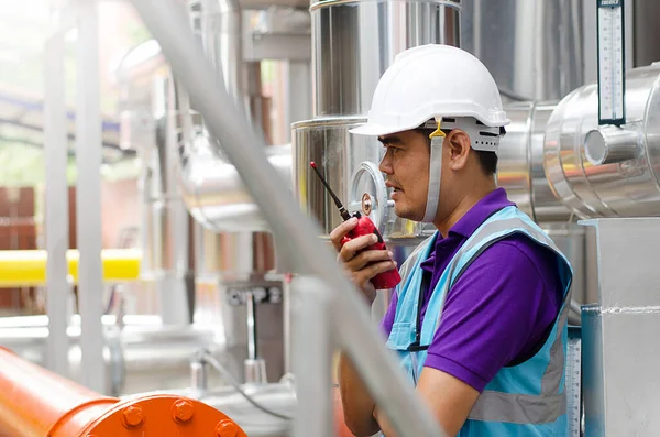 The senior engineer is checking the answers of the cooling system for the safety of the system