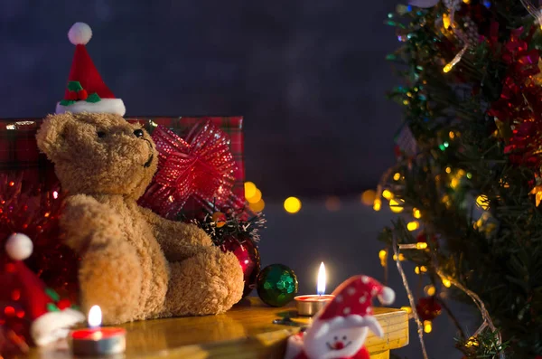 Teddy bear  with gifts near Christmas tree