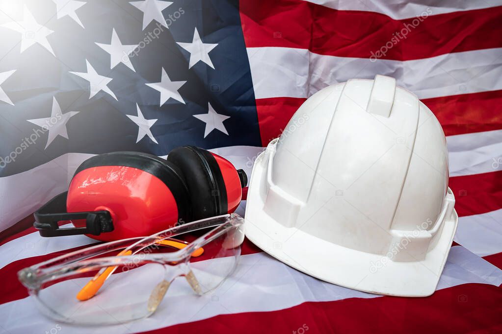 Labor Day ideas: hats and various labor protective equipment is placed on the flag of the United States 