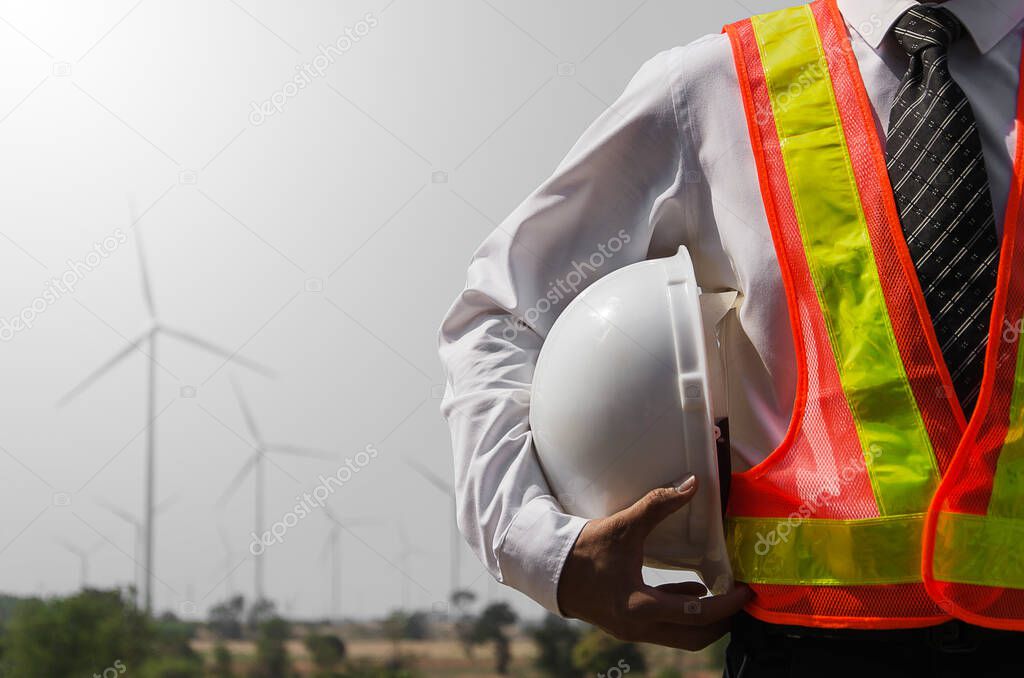worker with hard hat under arm 