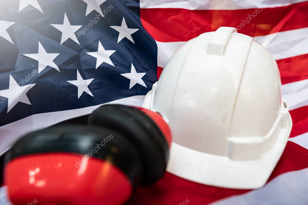 Labor Day ideas: hats and various labor protective equipment is placed on the flag of the United States