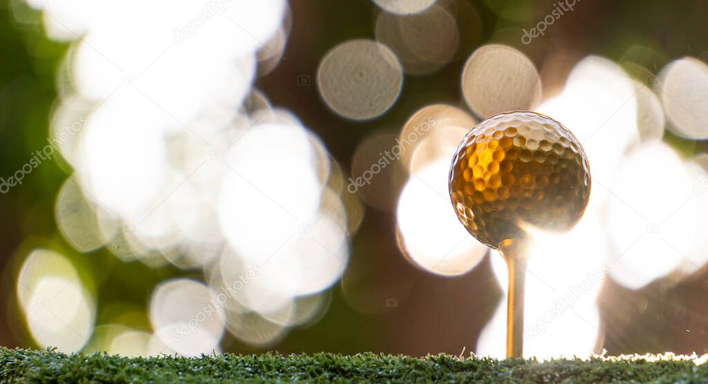 Gold golf ball and pin with a bright light, the ultimate victory