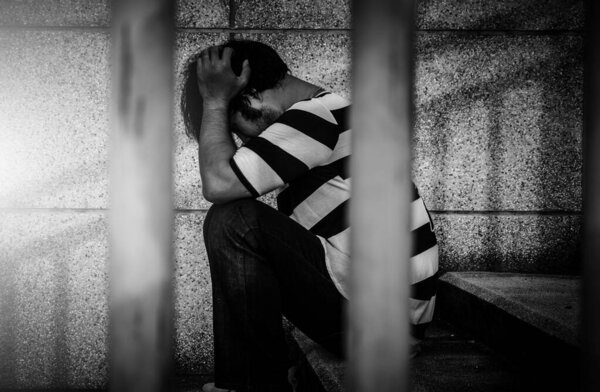 Asian depressed male prisoner                          