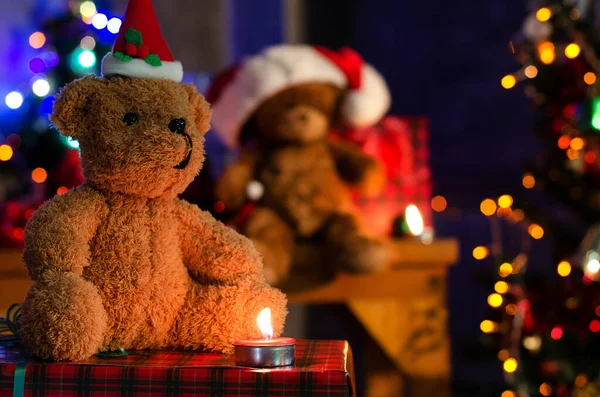 Teddy bear  with gifts near Christmas tree