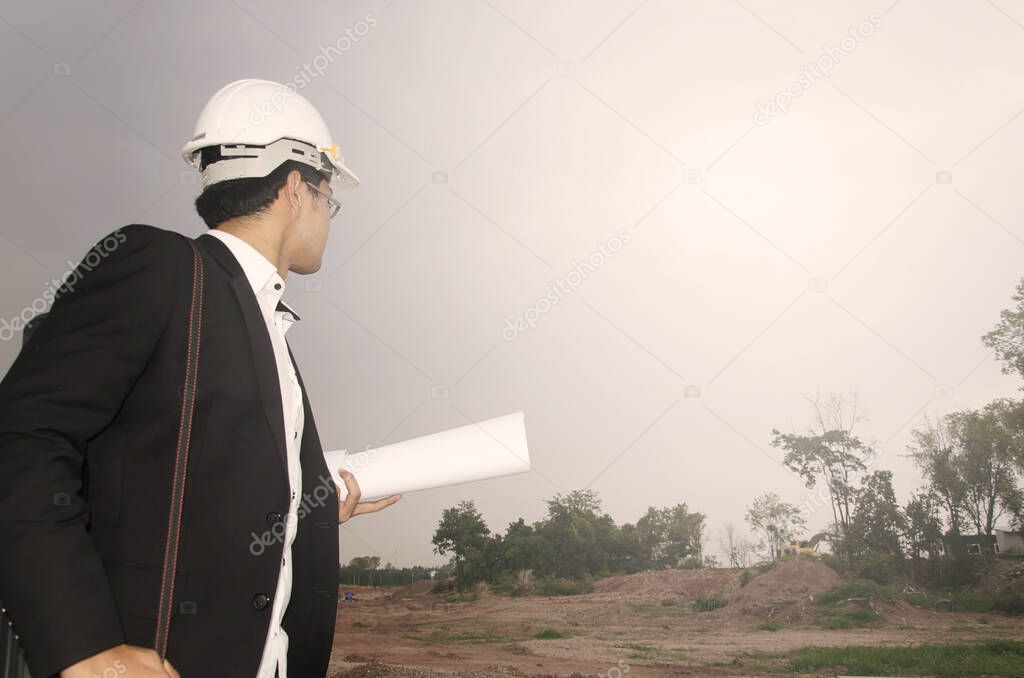 architect with blueprints on the construction  site