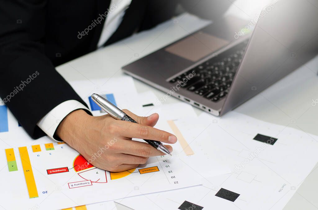 Business executives working in the Office with hands that are holding the pen