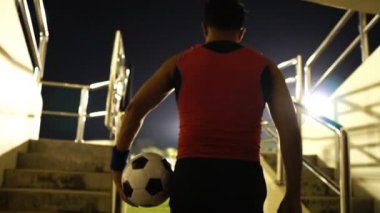 Football referee are holding the ball went into the field