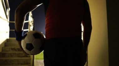 Football referee are holding the ball went into the field