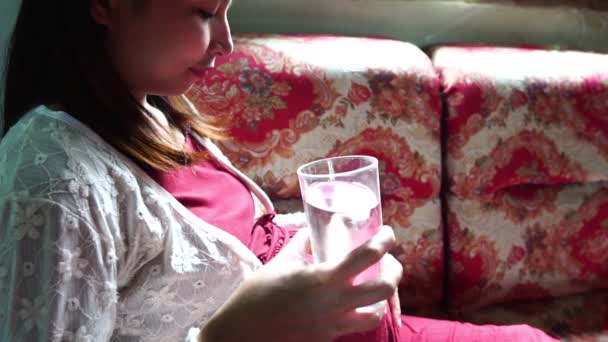 Young Pregnant Woman Sitting Sofa Drinking Water — Stock Video