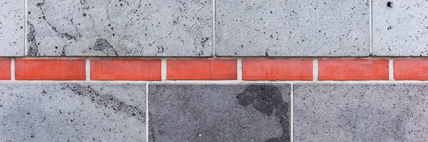 Parede cinzenta, interrompida por tijolos vermelhos — Fotografia de Stock