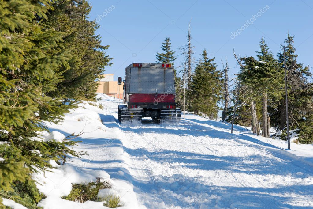 Large snowmobile in the winter forest