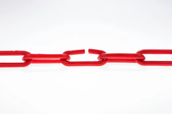 Red chain with broken element on white — Stock Photo, Image