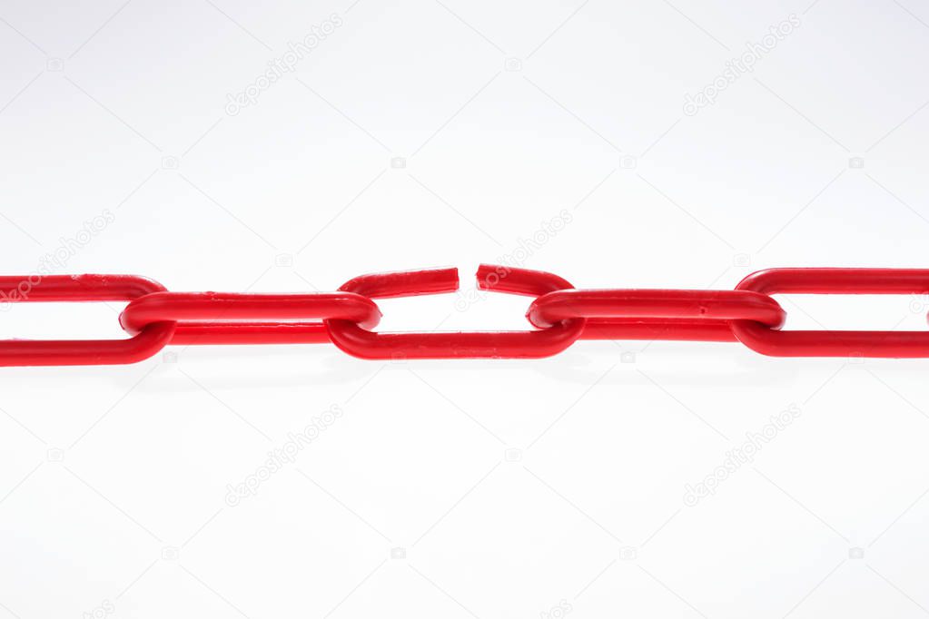Red chain with broken element on white
