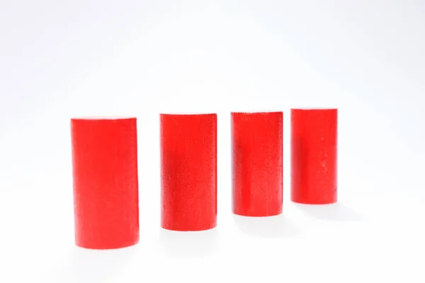 Four red round wooden building blocks in a row — Stock Photo, Image