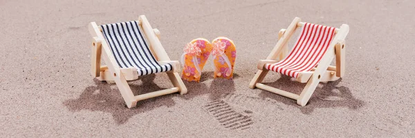 Two sun loungers on the beach