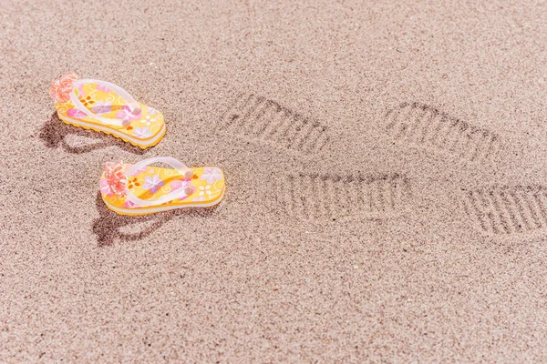 Shoe prints of flip flops at the beach