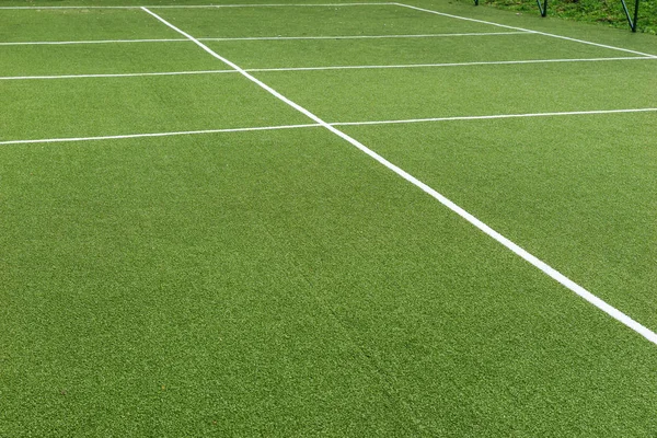 Green synthetic grass sports field with white line