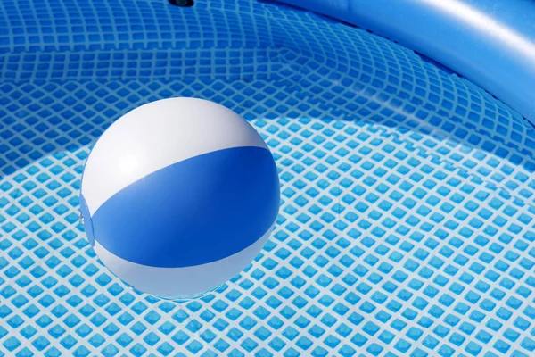 Beach ball floating in a swimming pool — Stock Photo, Image