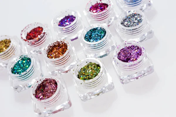 Colorful glitters in transparent jars — Stock Photo, Image