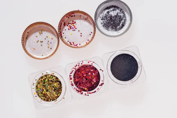 Black, red and golden glitters in jars — Stock Photo, Image