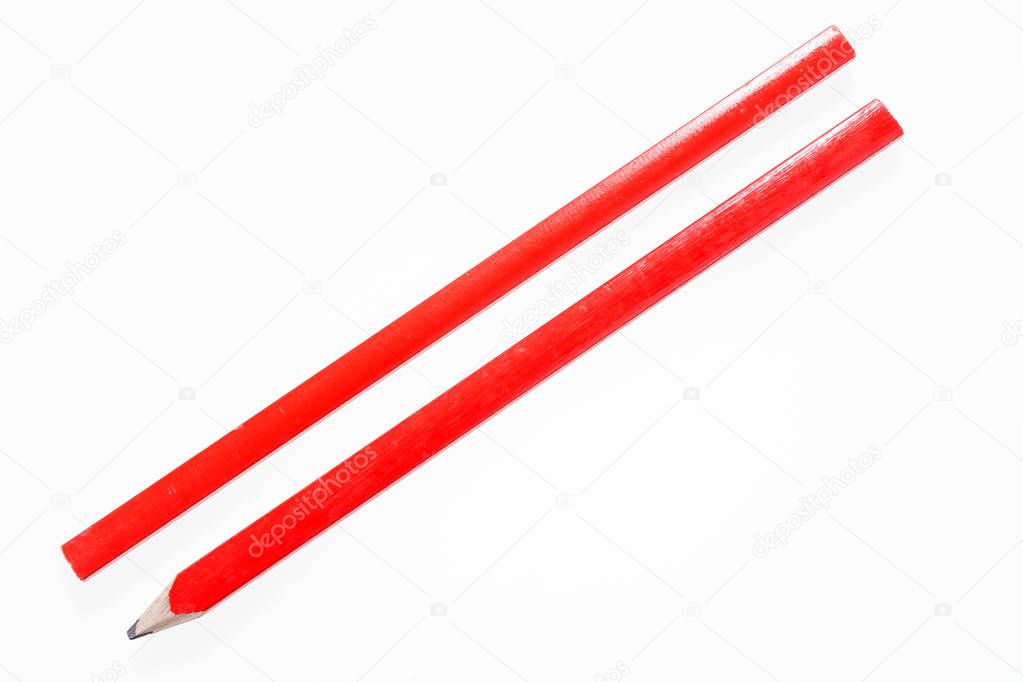 Two red construction pencils isolated on white