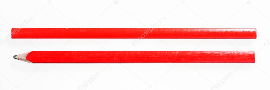 Two red construction pencils isolated on white